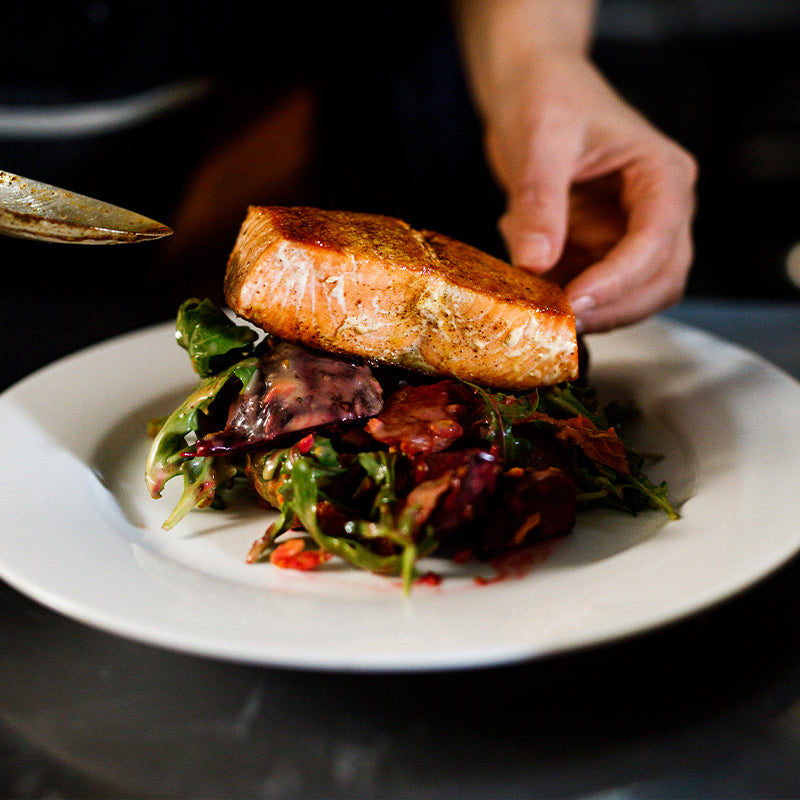 Wild Alaskan King Salmon fillet on plate, skin side down
