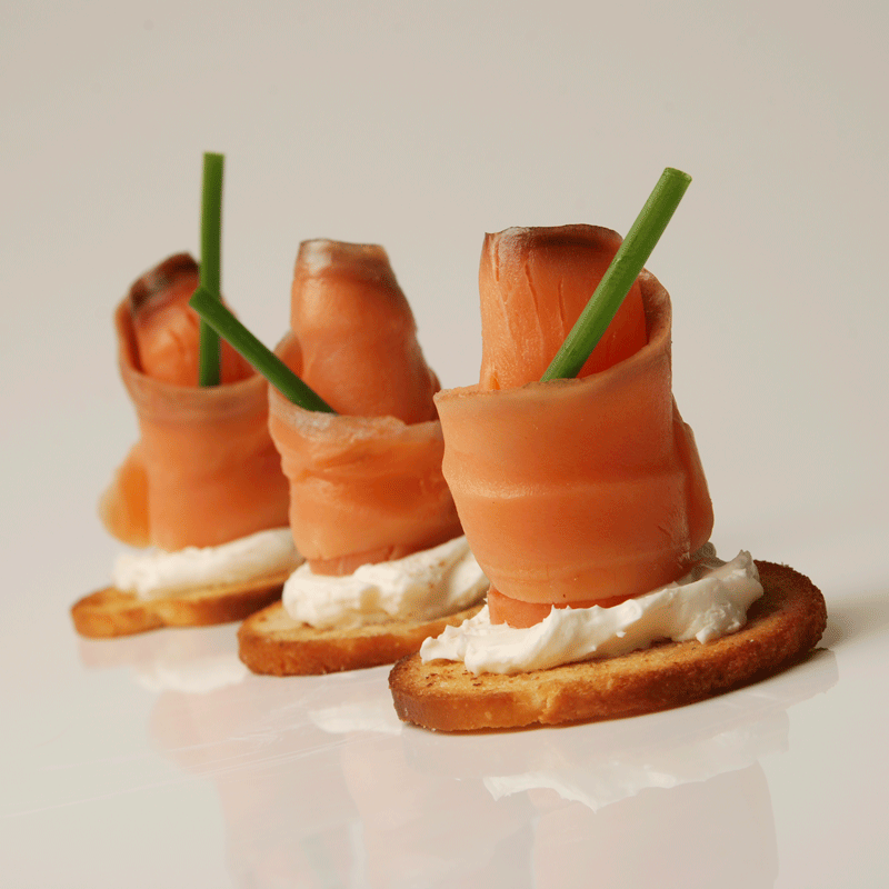 Cold smoked King Salmon lox plated with capers and bread