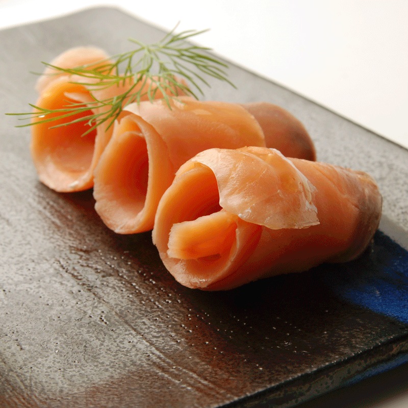 Cold smoked Red King Salmon lox rolled on platter