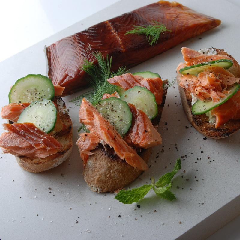 Hot smoked Coho Salmon served on board with crackers