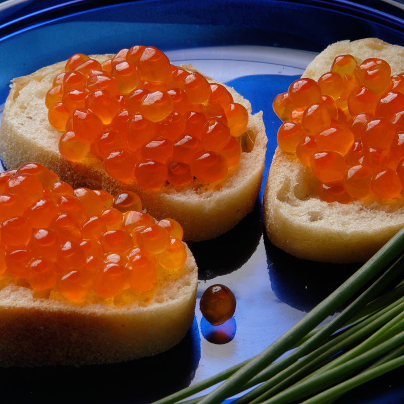Salmon caviar served on blini